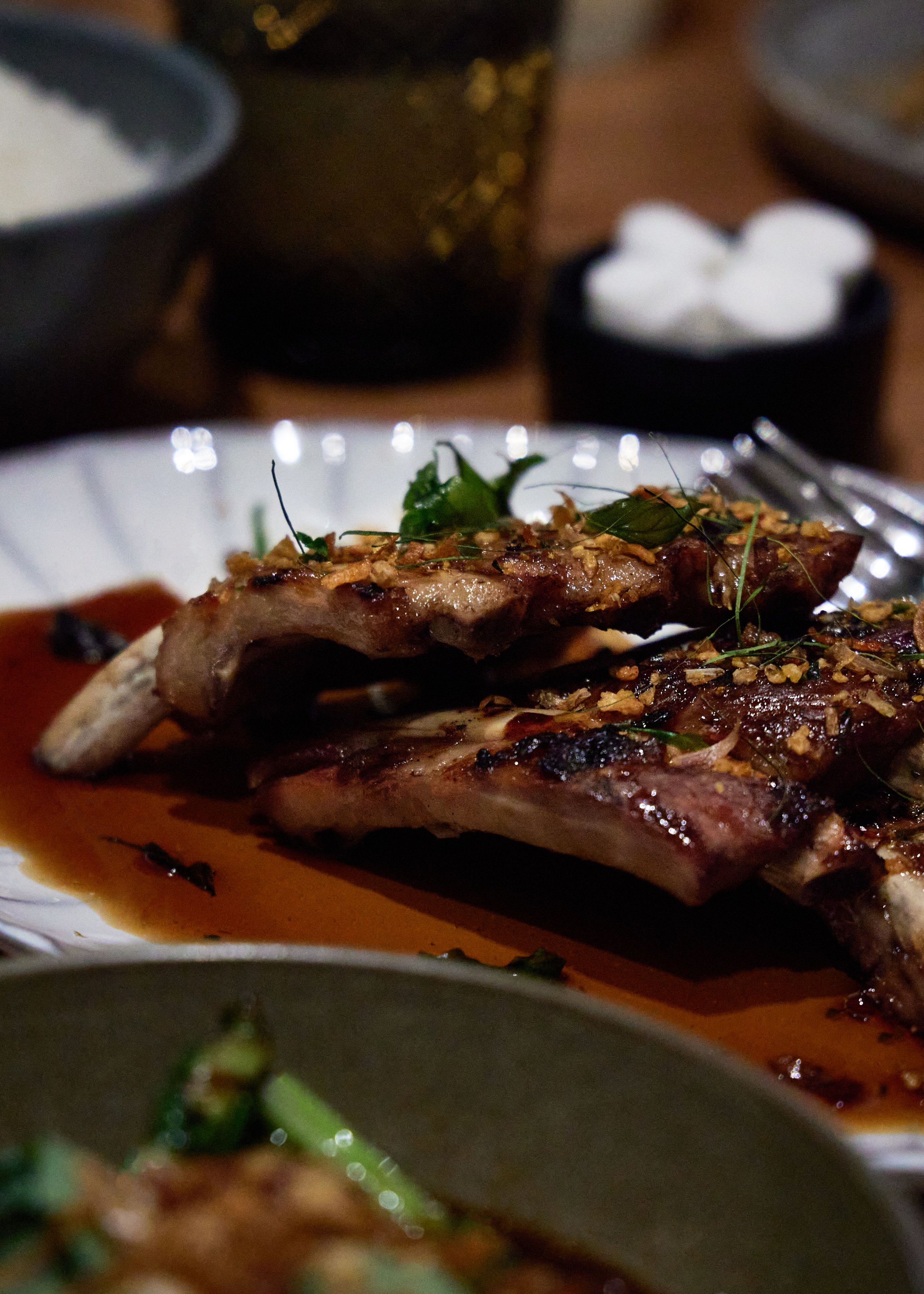 Ribs in their own sauce, served with sides on a wooden table